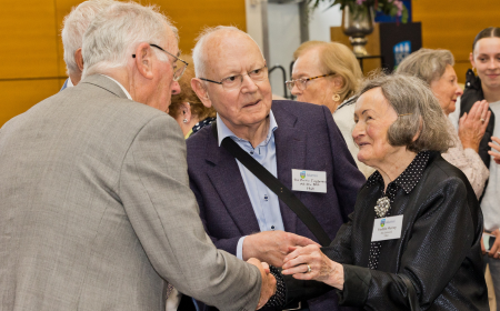 Three alumni mingling at their Golden & Diamond Jubilee Reunion 2024.